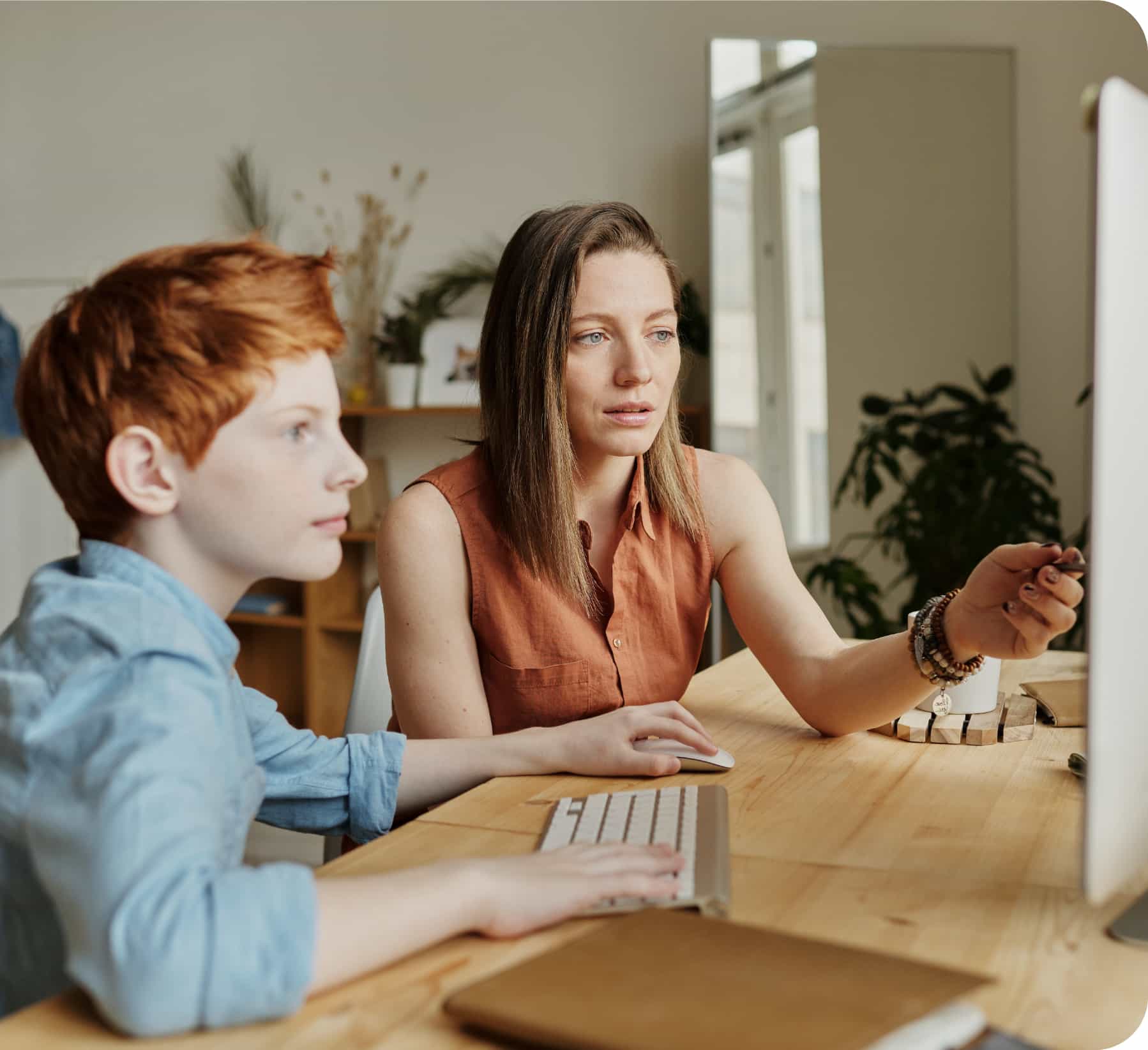 mother and son looking at computer completing school work
